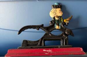 Vintage Hand Painted Cast Iron Revolutionary War Soldier Nutcracker on Red Wood